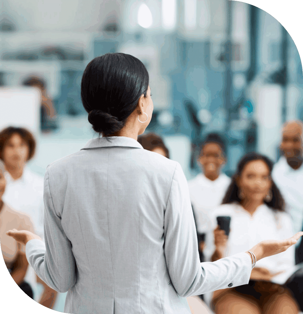 Woman presenting to a diverse audience.