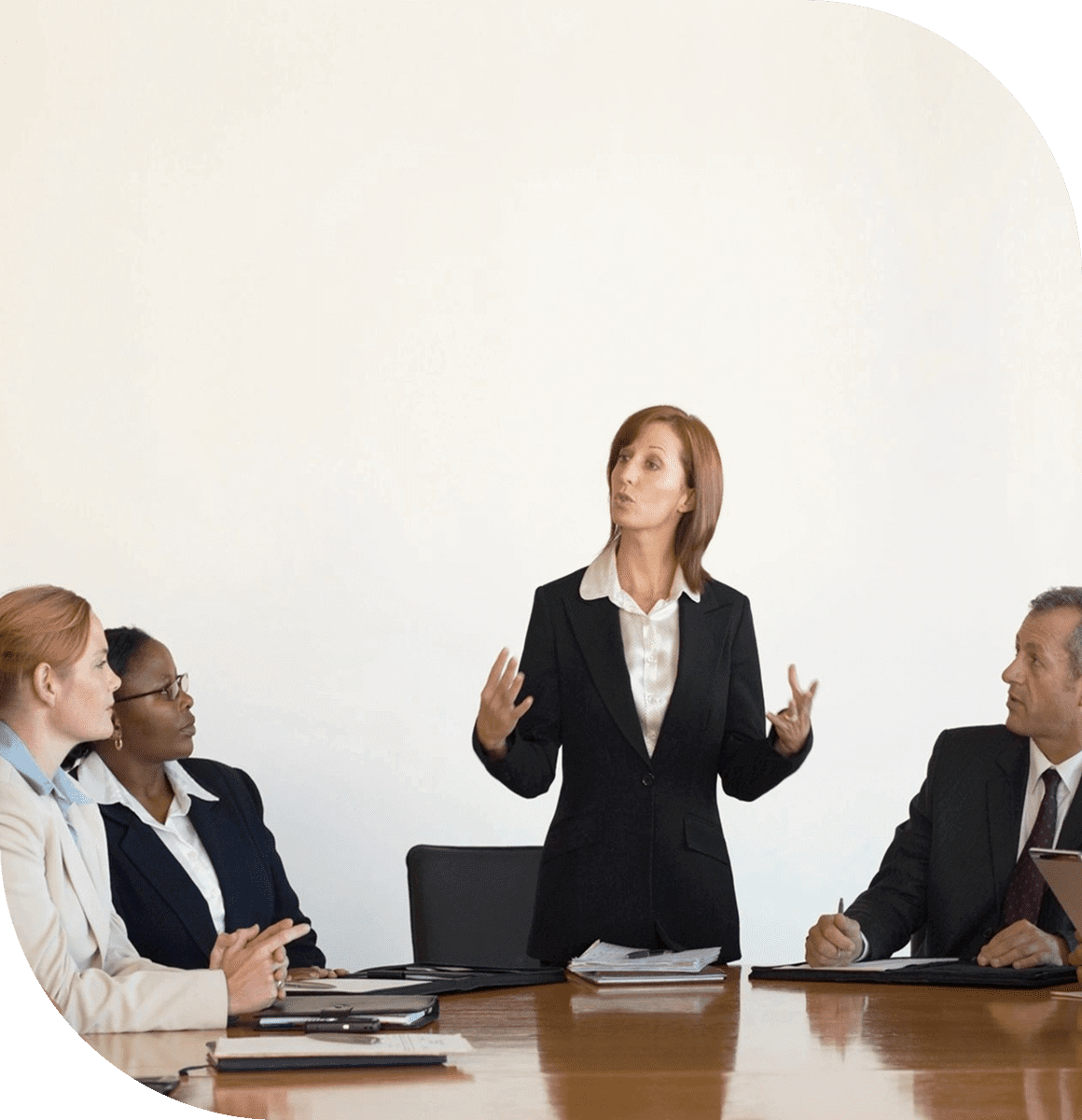A woman presenting to a group in a business meeting.